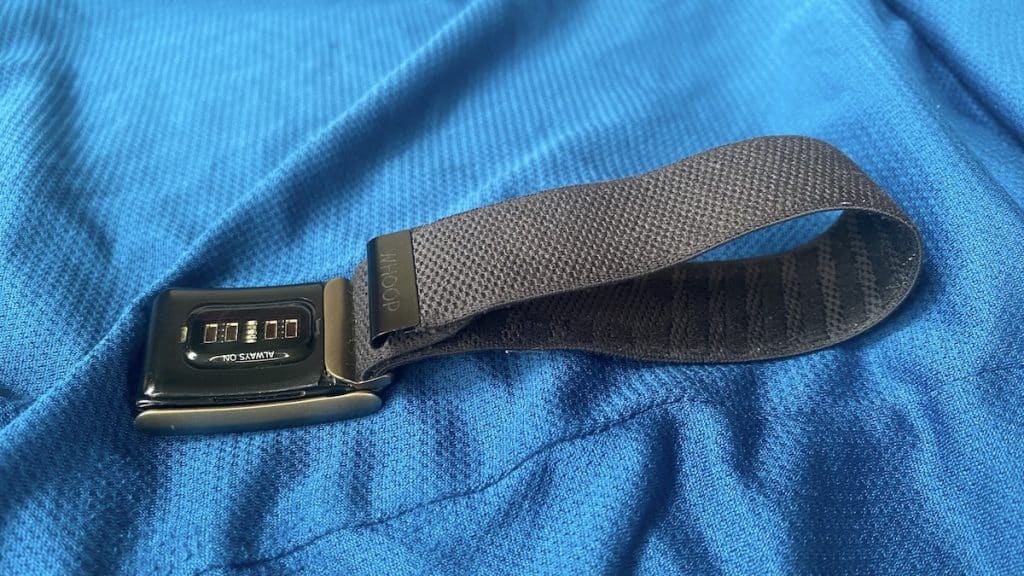 WHOOP band with its optical sensor visible on blue fabric